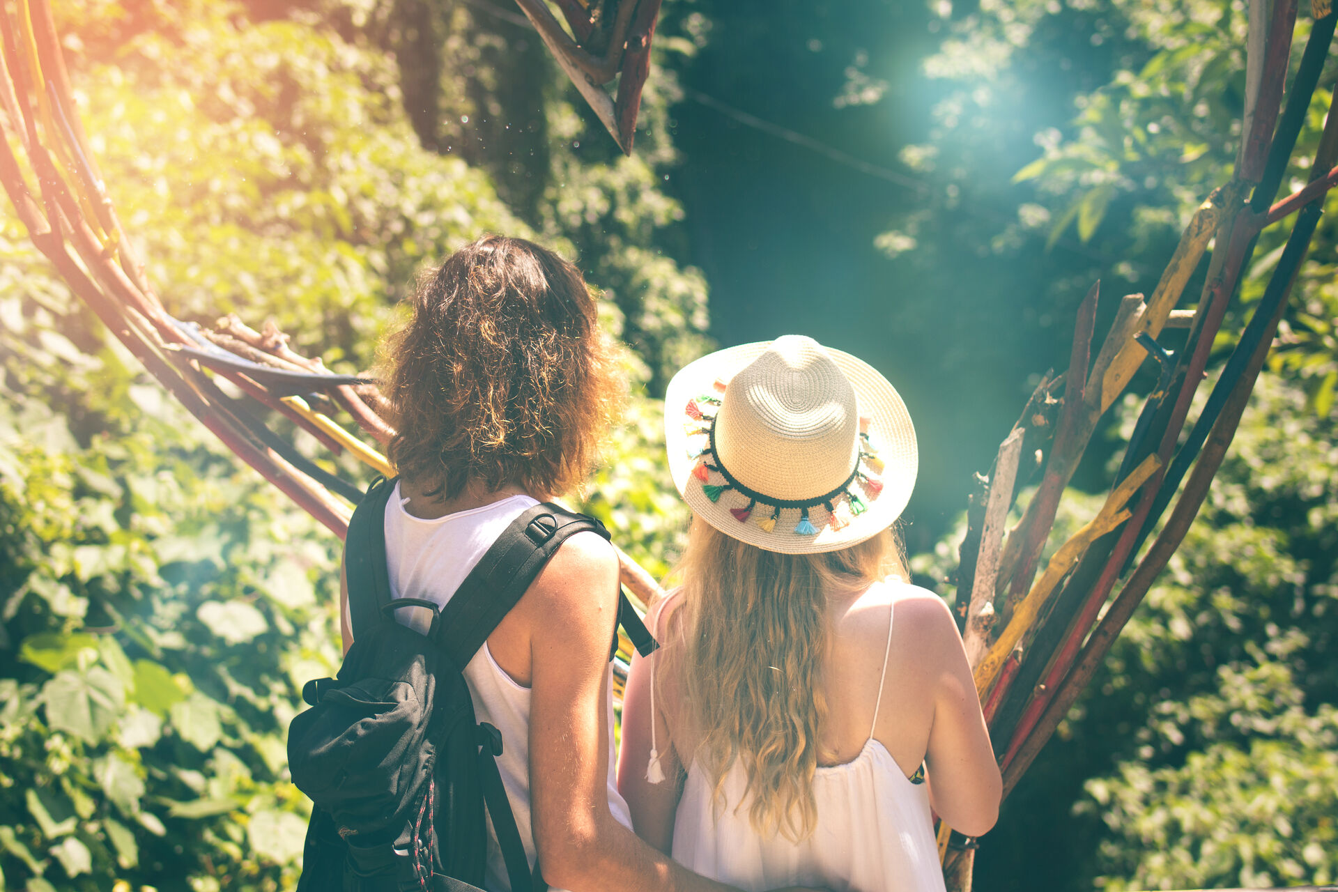 Couple hiking together through a lush jungle trail